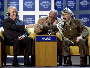 DAVOS/SWITZERLAND,28JAN01 - President of the Palestinian Authority Yasser Arafat (R) shakes hands with Minister of Regional Cooperation of Israel Shimon Peres (L) as an unidentified translater applauds at the beginning of a session entitled 'From Peacemaking to Peacebuilding' at the Annual Meeting 2001 of the World Economic Forum in Davos, January 28, 2001.
Byline: swiss-image.ch/Photo by Remy Steinegger
NO RESALES, NO ARCHIVES