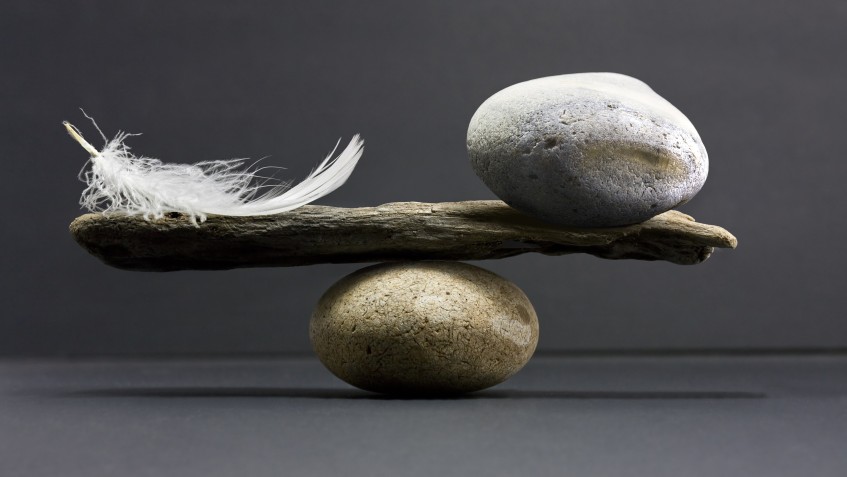 a feather and a stone equally balance