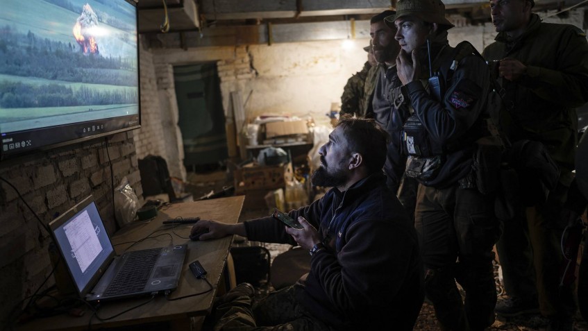 -- EMBARGO: NO ELECTRONIC DISTRIBUTION, WEB POSTING OR STREET SALES BEFORE 12:01 A.M. ET ON TUESDAY, NOV. 15, 2022. NO EXCEPTIONS FOR ANY REASONS -- FILE — A drone operator shares footage of an attack against a Russian position with fellow soldiers of the Ukrainian army’s Carpathian Sich Battalion at an underground base in the Kharkiv region of Ukraine, May 11, 2022. Though the battle for Ukraine remains largely a grinding artillery war, new advances in technology and training there are being closely monitored for the ways they are starting to shape combat. (Lynsey Addario/The New York Times) -- NO SALES --