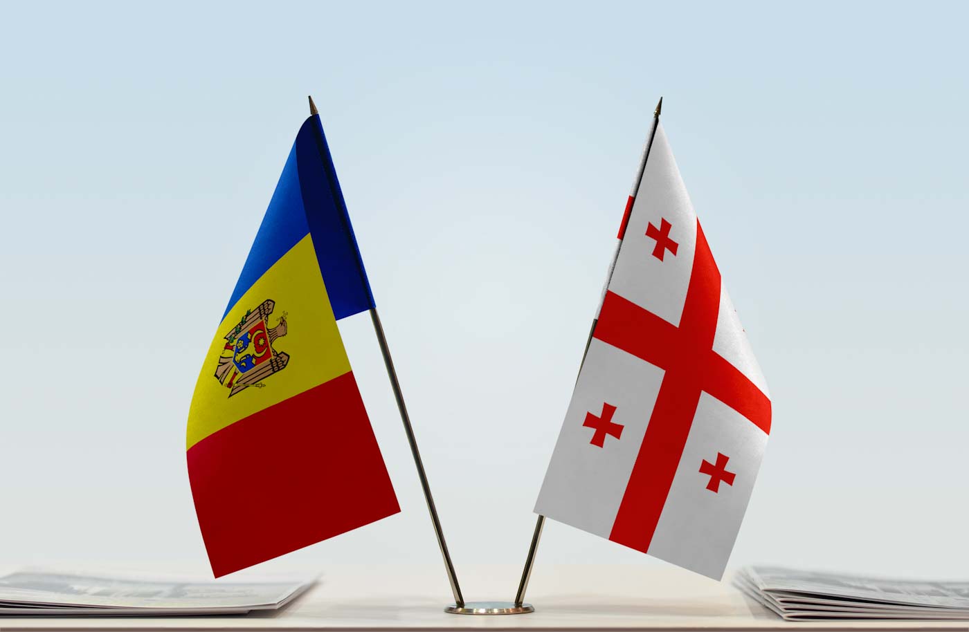Flags of Moldova and Georgia. Cloth of flags is 3d rendering, the rest is a photo.